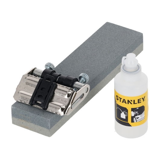 STANLEY 0-16-050 sharpening kit with honing guide, gray sharpening stone, and oil bottle, front angle.