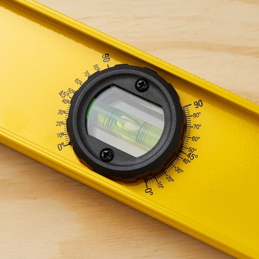 STANLEY 42-324 yellow spirit level with protractor vial, close-up showing angle markings.