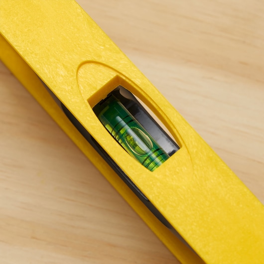 STANLEY 42-468 yellow level close-up, showing bubble vial, on wood surface.