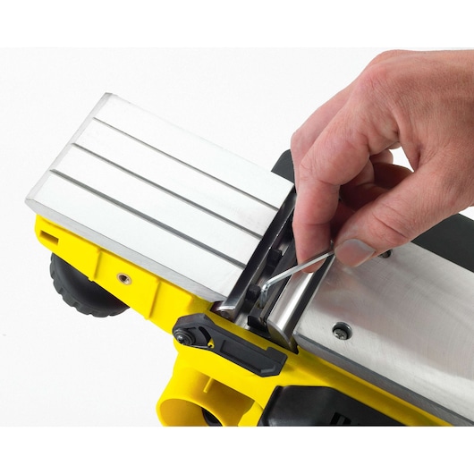 STANLEY STPP7502-B2 planer close-up, hand adjusting blade with hex key on silver and yellow tool.