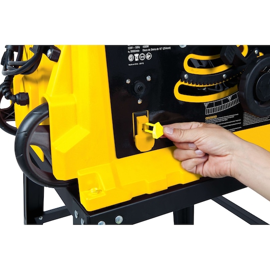 STANLEY STST1825 table saw photography, close-up of hand inserting yellow safety key.